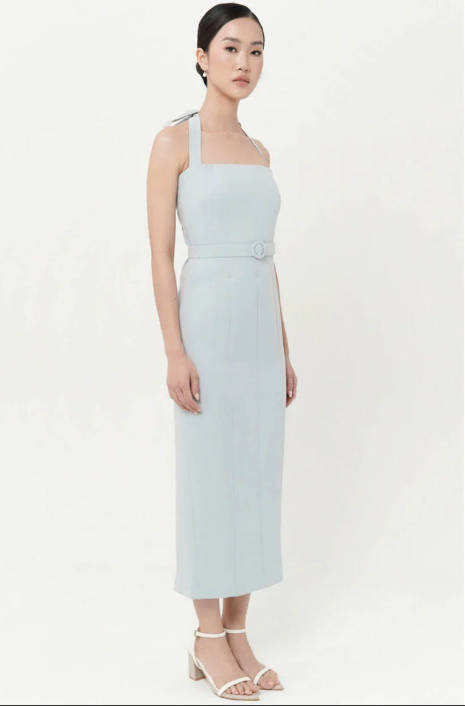 Woman wearing a light blue one-shoulder dress on a white background