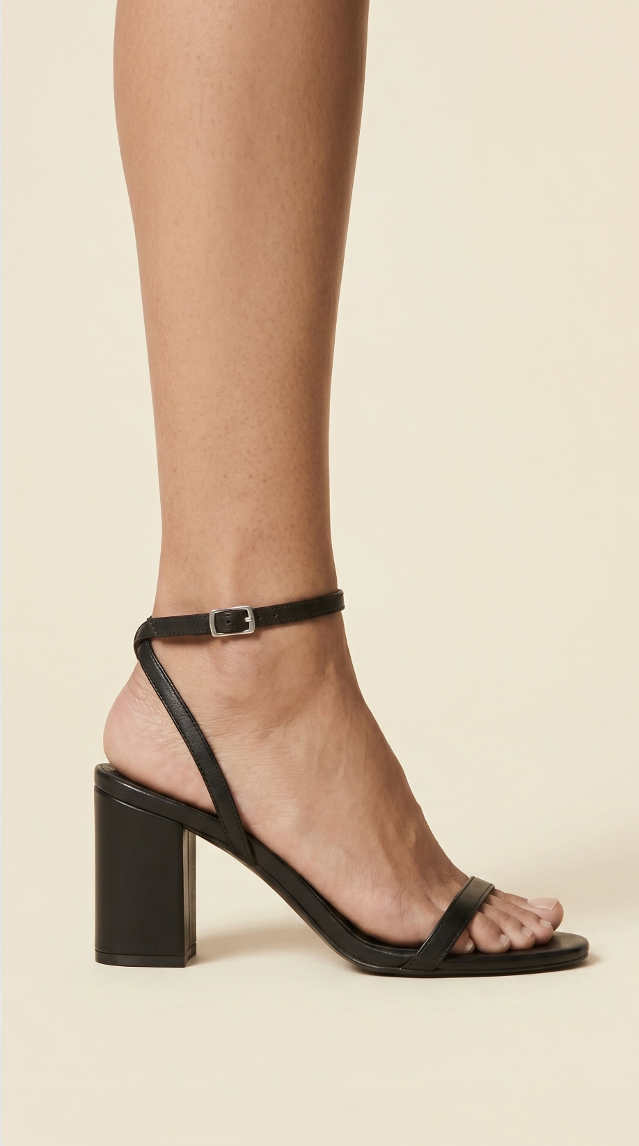 Black sandal on a beige background