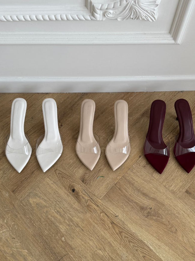 Set of high-heeled shoes in various colors on a wooden floor. nude (9 cm) nude (7 cm) nude (5 cm)  maroon (7 cm) white (7 cm)