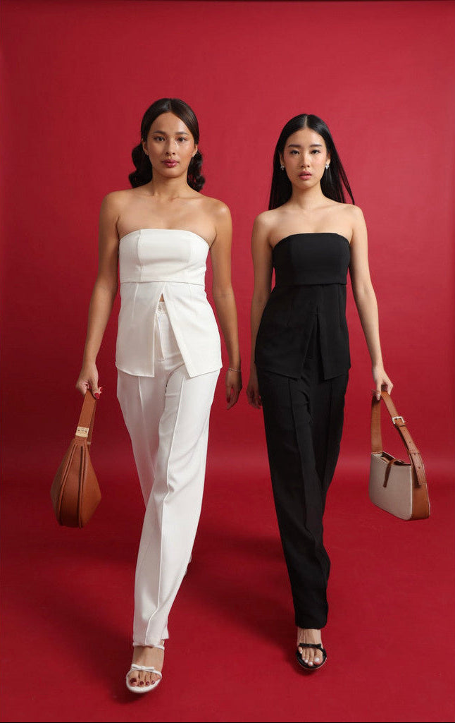 Two women in strapless outfits with pants, one in white and the other in black, holding handbags on a red background.black (7 cm) black (5 cm) white (7 cm) white (5 cm)