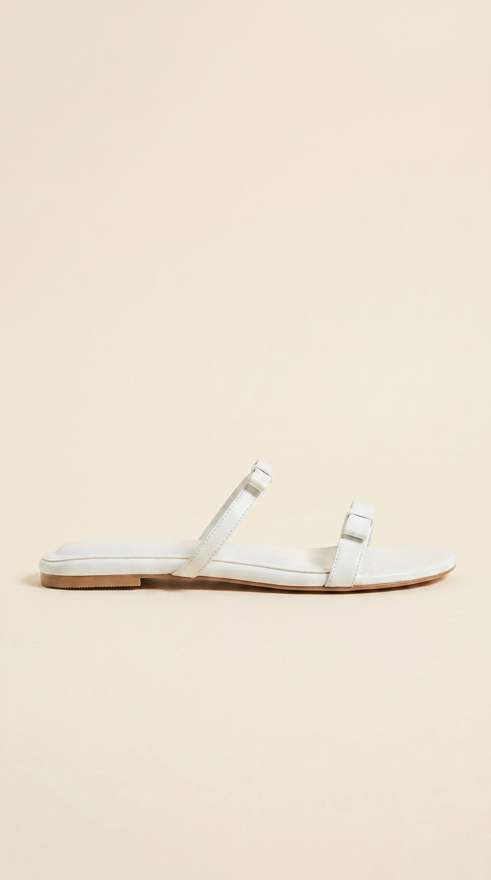 White sandal on a beige background
