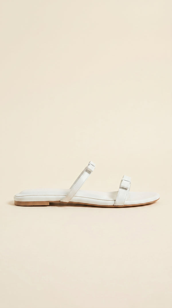 White sandal on a beige background